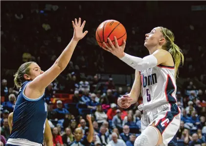  ?? Christian Abraham/Hearst Connecticu­t Media ?? UConn's Paige Bueckers (5) attempts a layup while defended by Villanova's Kaitlyn Orihel on Wednesday at Gampel Pavillion in Storrs.