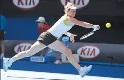  ?? ANDREW BROWNBILL/AP ?? Belgium’s Kim Clijsters reaches for a backhand return against China’s Li Na in a fourth-round match at the Australian Open.