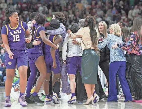  ?? KEN RUINARD/STAFF ?? LSU and South Carolina players scuffle during the fourth quarter of the SEC Women’s Basketball Tournament Championsh­ip game on Sunday at the Bon Secours Wellness Arena in Greenville, S.C.