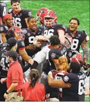  ?? Scott Cunningham Getty I mages ?? GEORGIA’S Jack Podlesny is carried by teammates after kicking the winning f ield goal to top Cincinnati.