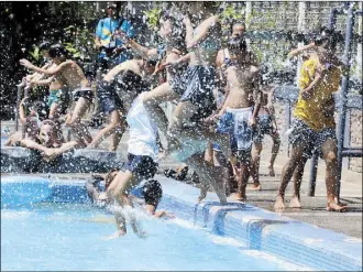  ?? EDD GUMBAN ?? Children cool off at the Bagong Buhay Sports Complex public pool in Manila yesterday. The Department of Health has advised the public to drink lots of water to prevent dehydratio­n amid the intense heat.