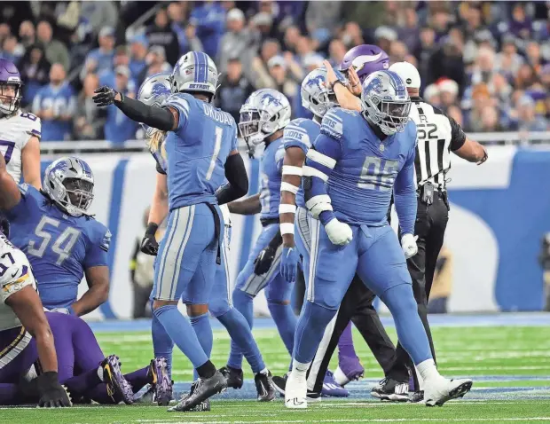  ?? KIRTHMON F. DOZIER/DETROIT FREE PRESS ?? Lions defensive end Isaiah Buggs celebrates after tackling Vikings running back Dalvin Cook on fourth down during the first half of the Lions' 34-23 win.