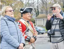  ??  ?? Re-enactor Pat Melanson chats with two of the passengers from the cruise ship MV Seabourn Quest during the ship’s port of call at Shelburne on Oct. 30.