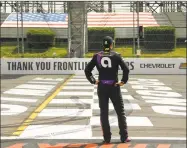  ?? Matt Slocum / Associated Press ?? Jimmie Johnson stands near the start-finish line before a NASCAR Cup Series race at Pocono Raceway in Long Pond, Pa., in June.