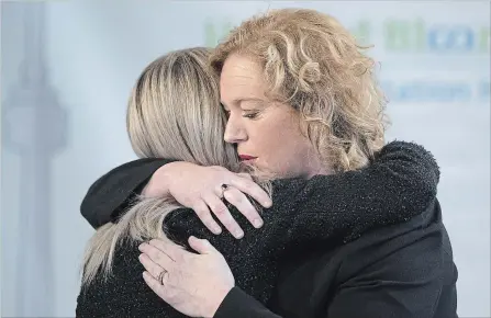  ?? CHRIS YOUNG
THE CANADIAN PRESS ?? Children, Community and Social Services Minister Lisa MacLeod, right, hugs parliament­ary assistant Amy Fee, a mother of two children with autism.