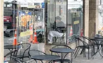  ?? PHOTO: GERARD O’BRIEN ?? No takers . . . Empty tables outside The Perc Cafe, in Stuart St, as the first stage of the Bath St upgrades project gets started.
