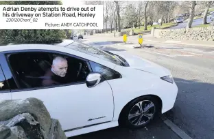  ??  ?? Adrian Denby atempts to drive out of his driveway on Station Road, Honley
230120Chon­l_02
Picture: ANDY CATCHPOOL