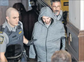  ?? CP PHOTO ?? Nicholas Butcher, one arm bandaged after he severed his hand with a power saw, arrives at provincial court in Halifax on Tuesday, April 12, 2016. Butcher, a Dalhousie law school graduate, has been charged with second-degree murder in the death of...