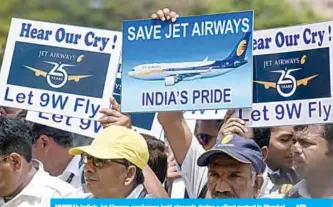  ??  ?? MUMBAI: India’s Jet Airways employees hold placards during a silent protest in Mumbai. —AFP