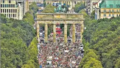  ?? REUTERS ?? People rally near the Brandenbur­g Gate in Berlin, protesting over Covid-19 curbs imposed by the German n
government. Thousands at the rally were seen chanting, ‘The pandemic is over.’
