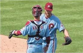  ?? BILL STREICHER/USA TODAY SPORTS ?? Phillies pitcher Zack Wheeler and catcher Andrew Knapp (5) celebrate after a 2-0 victory against the Brewers on Thursday.