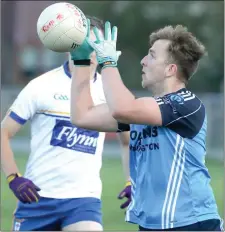  ??  ?? Conor O’Byrne (St Colmcille’s) catches the ball before turning towards goal.