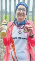  ?? ?? Mary Clare Healy, with the bottle of wine she received when crossing the line at the Wine on the Line 10k race in Kildare on Sunday, 12th March.