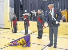  ??  ?? President Brinton Forbes holds the Bridgetown Royal Canadian Legion Branch 33 flag during The Last Post and two minutes of silence at the Remembranc­e Day Ceremony in Bridgetown Nov. 11.