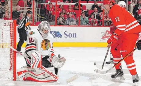  ?? | GETTY IMAGES ?? Goalie Corey Crawford makes a save on a shot by the Hurricanes’ Eric Staal. He stopped 43 shots in the Hawks’ 3- 1 victory Monday.