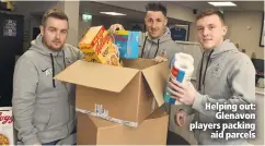  ??  ?? Helping out:
Glenavon players packing
aid parcels