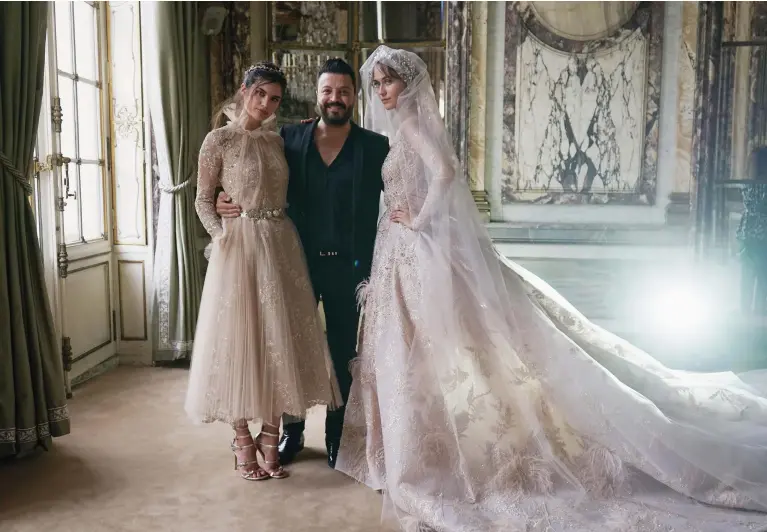  ??  ?? DESIGNS ON THE WORLD Zuhair Murad poses with models prior to this year’s haute couture show in Paris