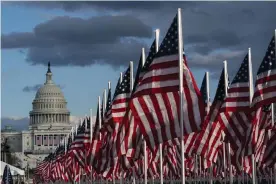  ?? Photograph: Alex Brandon/AP ?? American flags are placed on the National Mall, with the US Capitol behind, ahead of the inaugurati­on of President-elect Joe Biden and Vice President-elect Kamala Harris.