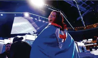  ?? Carolyn Kaster / Associated Press ?? Kim Federick, a convention volunteer from Houston, shows off her cape as she arrives for the first-day session of the Democratic National Convention in Philadelph­ia.