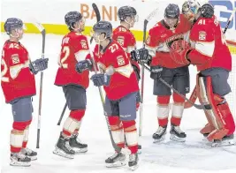  ?? MATIAS J. OCNER mocner@miamiheral­d.com ?? Panthers players congratula­te goalie Anthony Stolarz, who earned his second shutout of the season Tuesday in the win against Ottawa at Amerant Bank Arena in Sunrise.