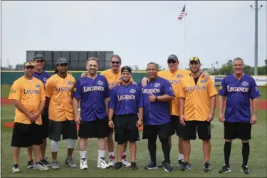  ?? ERIC BONZAR — THE MORNING JOURNAL ?? Legends from the gridiron and the baseball diamond came together for a night of laughs, memories and a little bit of softball for the inaugural Cleveland Sports Legend Game at Sprenger Stadium. From left to right are: Andrew Davis, Matt Wilhelm, Josh Cribbs, Bob Golic, Bernie Kosar, Carlos Baerga Jr., Carlos Baerga, Len Barker, Travis Hafner and Joe Charboneau.