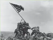  ??  ?? U.S. Marines on Feb. 23, 1945, raise the American flag atop Mount Suribachi, Iwo Jima, Japan.