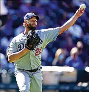  ??  ?? Los Angeles Dodgers starting pitcher Clayton Kershaw, right, throws to first base to put out Colorado Rockies’ Raimel Tapia in the third inning of a baseball game Thursday in Denver.