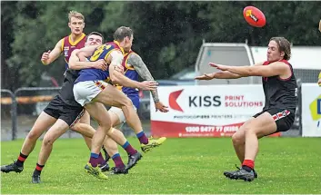  ?? ?? Warragul’s Patrick Mulqueen lays a tackle on Moe’s Lucas Forato while Mulqueen’s teammate Kai MacLean attempts to smother.