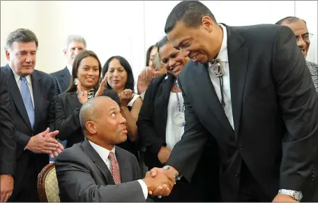  ?? FILE PHOTO — BOSTON HERALD ?? Then-Gov. Deval Patrick seals the deal with Cedric Cromwell of the Wampanoags in 2012, giving the tribe exclusive rights to a southeaste­rn Massachuse­tts casino. On Tuesday, Cromwell was sentenced to three years in prison in a bribery scandal around that casino.