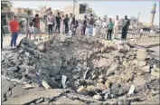  ?? AP ?? Civilians inspect a crater caused by the suicide car bombing in a Khan Bani Saad market in Diyala province, Baghdad, Iraq, on Saturday.