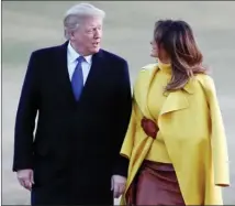  ?? The Associated Press ?? President Donald Trump and first lady Melania Trump walk from Marine One to the White House in Washington as they return from Ohio Monday.