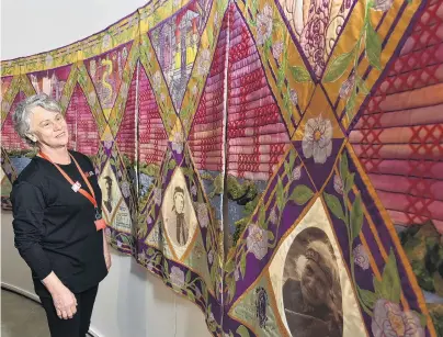  ?? PHOTO: GREGOR RICHARDSON ?? History in panels . . . Toitu Otago Settlers Museum visitor host Cora Woodhouse admires embroidere­d panels highlighti­ng some leading and trailblazi­ng Dunedin women.