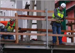  ?? JIM WILSON — THE NEW YORK TIMES ?? The labor market has remained strong, with hiring persisting in sectors like constructi­on. Above, constructi­on workers at a job site in San Francisco in January.