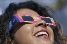  ?? Fernando Llano/Associated Press ?? Bottom left: People use special glasses to watch the eclipse in Mazatlan, Mexico.