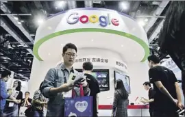  ?? Andy Wong Associated Press ?? GOOGLE’S work on artificial intelligen­ce in China has drawn criticism in some circles. Above, visitors gather at a Google booth during a 2016 Beijing conference.