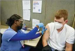  ?? MARY ALTAFFER — THE ASSOCIATED PRESS FILE ?? A registered nurse gives James Mullen the second dose of the coronaviru­s vaccine at a COVID-19 vaccinatio­n site at NYC Health + Hospitals Metropolit­an in New York.