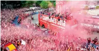  ?? AFP ?? Atletico Madrid’s players parade aboard an open-top bus. —