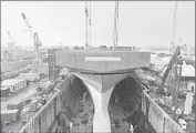  ?? Billy Cullen BAE Systems ?? WORKERS in Rosyth, Scotland, attach a bow to an aircraft carrier in February. Vessels for Britain’s Royal Navy will be built only in Scotland.