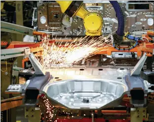  ?? AMR ALFIKY — THE ASSOCIATED PRESS FILE ?? Machines at work on a Ford vehicle assembly line at Ford’s Chicago Assembly Plant. American factories expanded at a faster pace last month, continuing a rebound from the coronaviru­s recession.