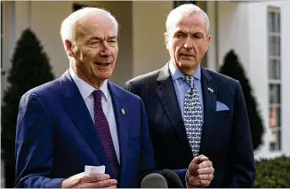  ?? ALEX BRANDON/ASSOCIATED PRESS ?? Govs. Asa Hutchinson (left), R-ark., and Phil Murphy, D-N.J., speak with reporters on Monday after meeting with President Joe Biden in the East Room of the White House during the National Governors Associatio­n conference.