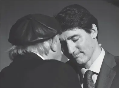  ?? NATHAN DENETTE / THE CANADIAN PRESS ?? Holocaust survivor Nate Leipciger shares a moment with Prime Minister Justin Trudeau on Tuesday after the PM delivered remarks at the March of Living 30th anniversar­y gala in Toronto.