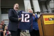  ?? ELIZABETH FRANTZ / CONCORD MONITOR VIA AP ?? Gov. Chris Sununu is gifted a jersey signed by Tom Brady from New England Patriots owner Robert Kraft Tuesday.