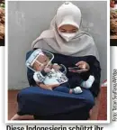  ??  ?? Diese Indonesier­in schützt ihr Baby mit einem Visier vor Ansteckung mit Coronavire­n.