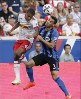  ?? JULIO CORTEZ — THE ASSOCIATED PRESS ?? Red Bulls midfielder Tyler Adams, left, and Impact defender Daniel Lovitz compete for the ball during the first half Saturday in Harrison, N.J.