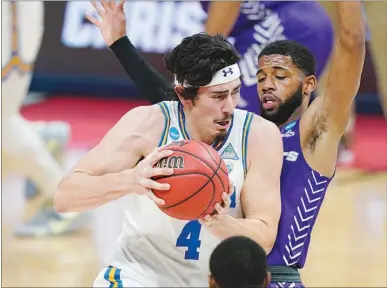  ?? MARK HUMPHREY / AP ?? UCLA’S Jaime Jaquez Jr.
(4) drives against Abilene Christian’s Reggie Miller in their second round NCAA Tournament game Monday at Bankers Life Fieldhouse in Indianapol­is. UCLA won the gameandwil­l face Alabama as a 6.5-point underdog Sunday in the Sweet 16.