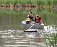  ?? CITIZEN FILE PHOTO ?? City employees Brent Collison and Keith Stibrany use a boat to set out an aerator pump in Hudson’s Bay Wetland in 2015.