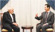  ?? Syrian Arab News Agency ?? Bashar al-Assad (right) and Iran Foreign Minister Mohammad Javad Zarif discuss ending the war.