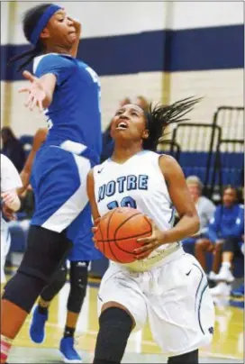  ?? KYLE FRANKO — TRENTONIAN PHOTO ?? Notre Dame’s Eve Crawford (13) goes up for a shot as Ewing’s MyAsia Jackson (12) attempts to block it during Wednesday night’s game.