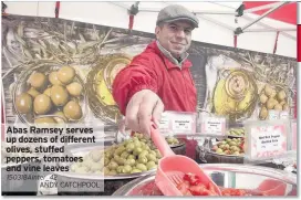  ?? ANDY CATCHPOOL ?? Abas Ramsey serves up dozens of different olives, stuffed peppers, tomatoes and vine leaves 150318Aint­er_42