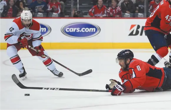  ?? AP PHOTO ?? Washington Capitals left wing Alex Ovechkin reaches for the puck against Carolina Hurricanes center Greg McKegg (42) during the second period of Game 7 of an NHL hockey first-round playoff series on Wednesday in Washington.